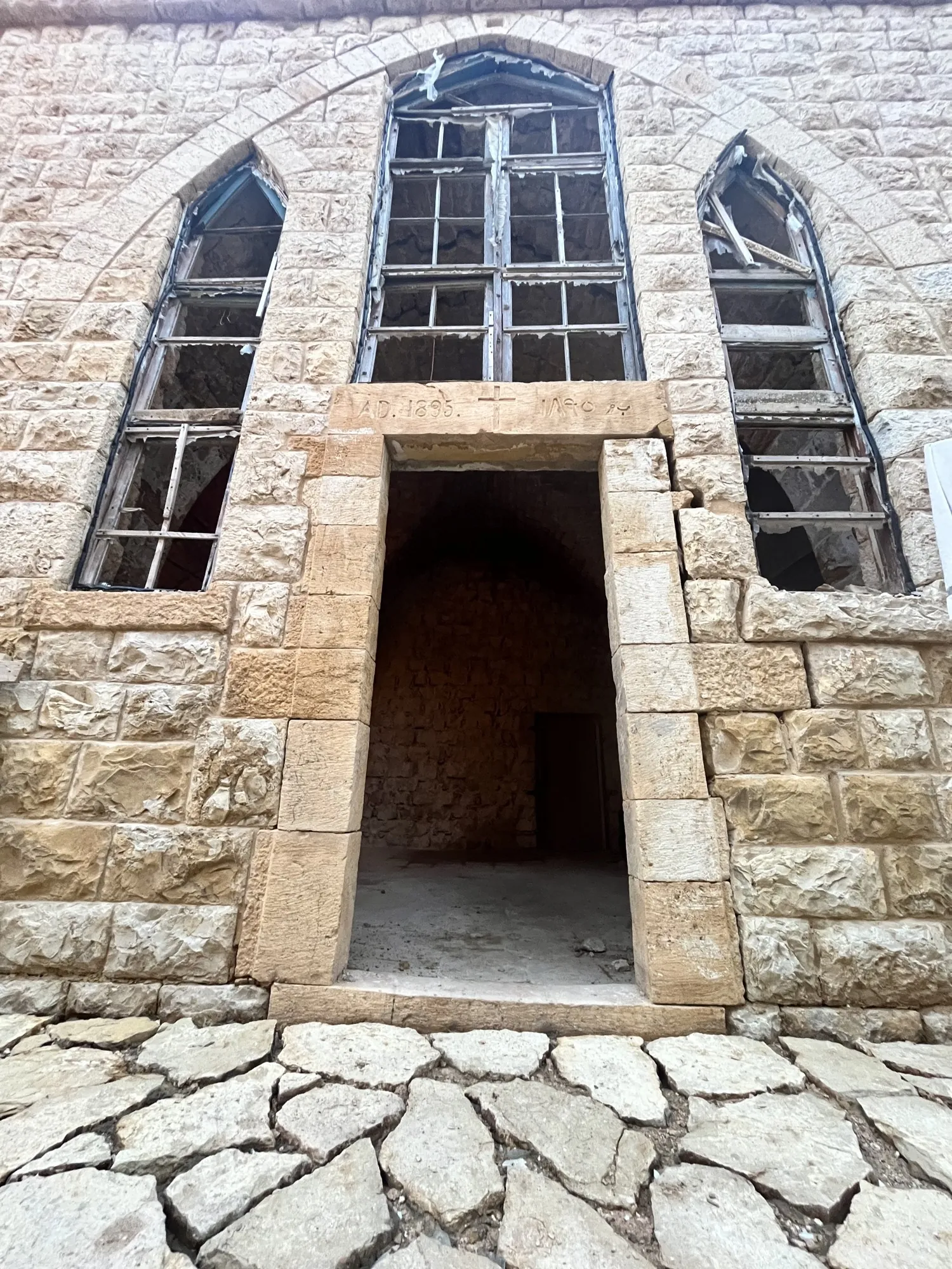 The real doorway of Qasr Noun today, its 1895 lintel above an open stone door